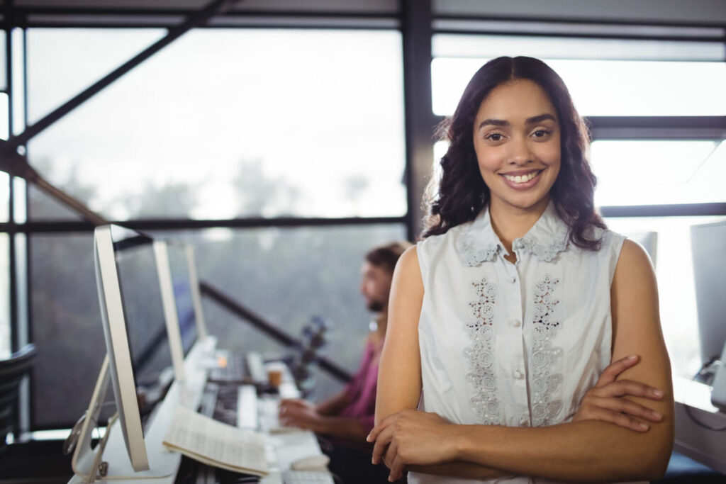 Portrait of hispanic female in office looking for grants for hispanic business owners