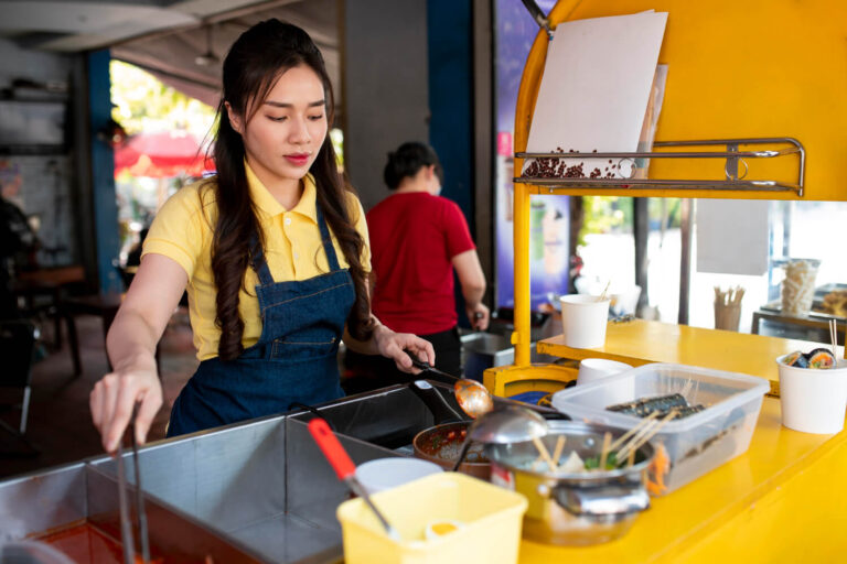 Medium shot woman working in a food truck