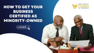 Two minority business owners review documents on how to get certified.